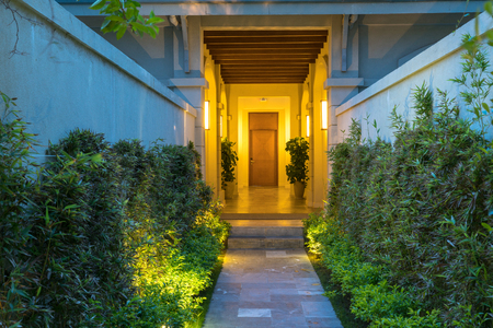 Garden path in resort with warm light and trees on side at evening, Garden Decoration.の写真素材