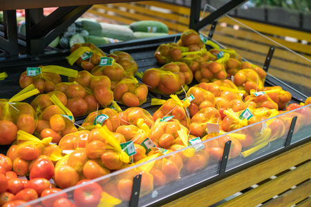 Fresh healthy fruits on shelves in supermarket. Ripe tomatoの写真素材