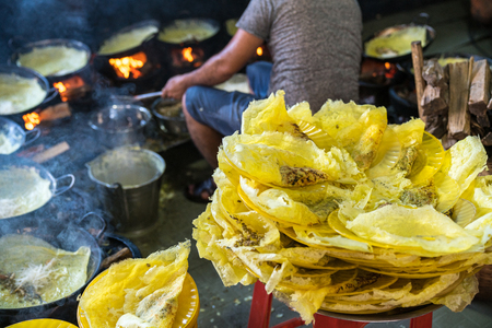 Banh xeo, Vietnamese traditional street food yellow crispy rice flour cake. Sizzling cake, named for the loud sizzling sound it makes when the rice batter is poured into the hot skilletの写真素材