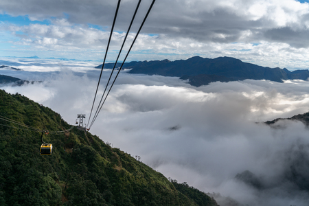 The cable car to mountain top with low clouds and mountain viewの写真素材