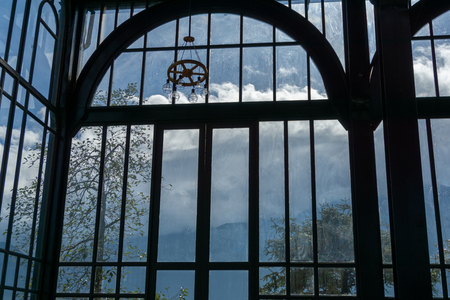 Modern building glass window wall with green trees and blue skyの写真素材