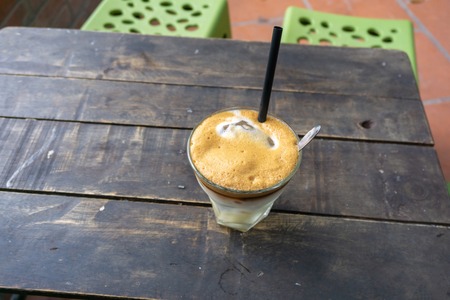 Coffee cup on vintage wooden table. Hot milk coffeeの写真素材