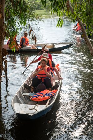 Chau Doc, Vietnam - Oct 13, 2018: Closeup tourism rowing boat in cajuput forest in floating water season in Mekong delta, Vietnamのeditorial素材