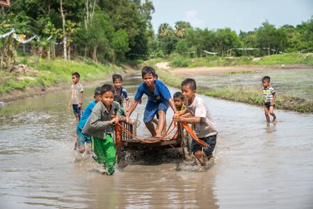 Chau Doc, Vietnam - Oct 13, 2018: Vietnamese children playing on muddy water fieldのeditorial素材