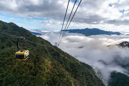 Lao Cai, Vietnam - Jan 3, 2019: The cable car to Fansipan mountain top with low clouds and mountain view in Sapa townのeditorial素材