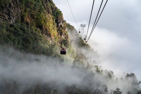 Lao Cai, Vietnam - Jan 3, 2019: The cable car to Fansipan mountain top with low clouds and mountain view in Sapa townのeditorial素材