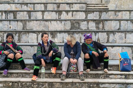 Sapa, Vietnam - Sep 11, 2018: Local ethnic minority people helping tourist to find the locationのeditorial素材