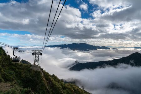 Lao Cai, Vietnam - Jan 3, 2019: The cable car to Fansipan mountain top with low clouds and mountain view in Sapa townのeditorial素材