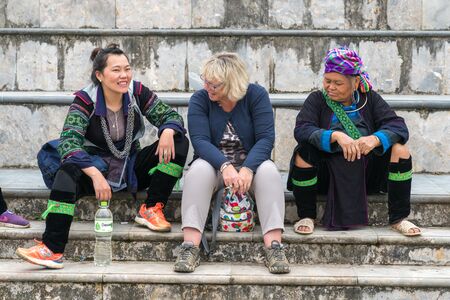 Sapa, Vietnam - Sep 11, 2018: Local ethnic minority people helping tourist to find the locationのeditorial素材