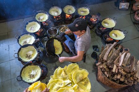Chau Doc, Vietnam - Oct 13, 2018: Vietnam man cooking Banh xeo (sizzling cake), Vietnamese traditional street food yellow crispy rice flour cakeのeditorial素材