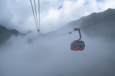 Lao Cai, Vietnam - Jan 3, 2019: The cable car to Fansipan mountain top with low clouds and mountain view in Sapa townのeditorial素材