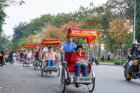 Hanoi, Vietnam - Feb 13, 2019: Hanoi street in fall season with yellow red leaves on branches. The "leaf change" seasonのeditorial素材