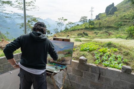 Ha Giang, Vietnam - Nov 22, 2018: An artist painting an autumn landscape in Quan Ba districtのeditorial素材