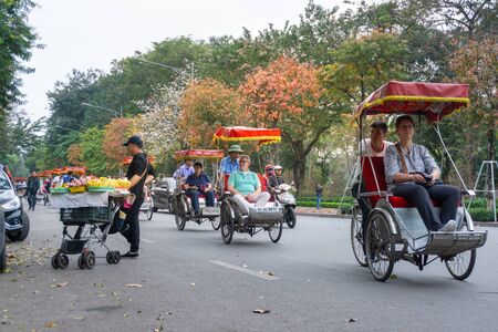 Hanoi, Vietnam - Feb 13, 2019: Hanoi street in fall season with yellow red leaves on branches. The "leaf change" seasonのeditorial素材