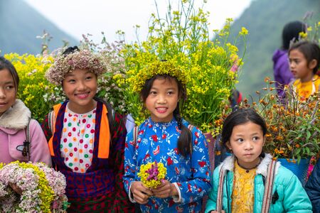 Ha Giang, Vietnam - Nov 24, 2018: Ethnic minority children with flower basket on back in Quan Ba districtのeditorial素材