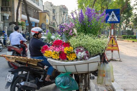 Hanoi, Vietnam - Feb 18, 2010: Flower basket on bike of street vendor on Thuy Khue street in Hanoiのeditorial素材
