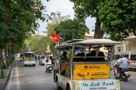 Hanoi, Vietnam - Mar 1, 2019: Electric car with 3 flags of Vietnam, North Korea and US running on street during the NKRP-USA Hanoi Summit, a meeting between Chairman Kim Jong-un and President Donald Trumpのeditorial素材