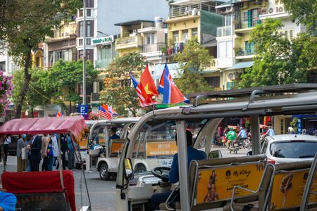 Hanoi, Vietnam - Mar 1, 2019: Electric car with 3 flags of Vietnam, North Korea and US running on street during the NKRP-USA Hanoi Summit, a meeting between Chairman Kim Jong-un and President Donald Trumpのeditorial素材