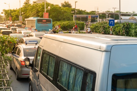 Cars on urban street in traffic jam at rush hour in big city