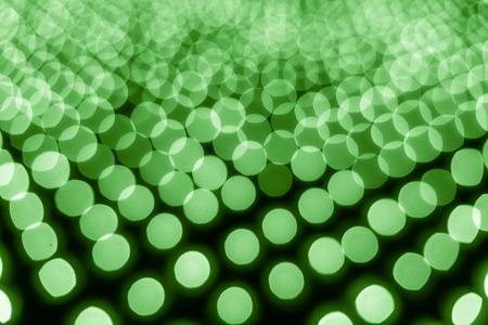 Abstract bokeh background. Soft defocused lights. Neon basic green colorの写真素材