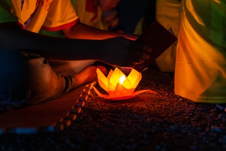 Colored lanterns and garlands at night on Vesak day for celebrating Buddha's birthday in Eastern culture, that made from paper and candleの写真素材