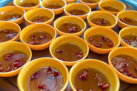 Many bowls of Vietnamese fish sause, the important food in Vietnamの写真素材