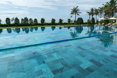Swimming pool at tropical villa resort by the seaの写真素材
