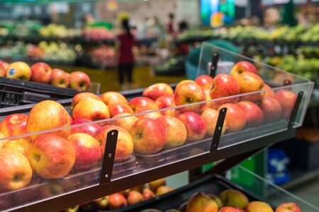 Fresh healthy fruits on shelves in supermarketの写真素材