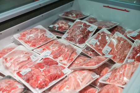 Raw meat in plastic box in supermarketの写真素材