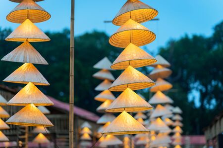 Vietnamese traditional conical hats hanging on wire for decoration.の写真素材