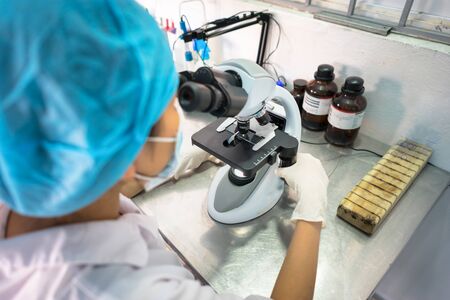 Asian technician tests the quality of product in laboratory closeupの写真素材