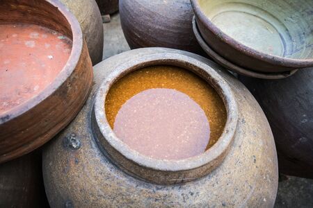 Jars of processing soybean jam made by traditional outdoor way under natural sunlightの写真素材