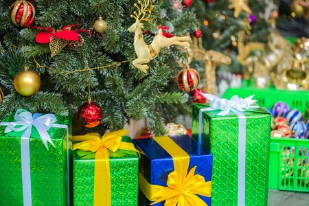 Christmas decorations on a christmas tree with gifts boxesの写真素材