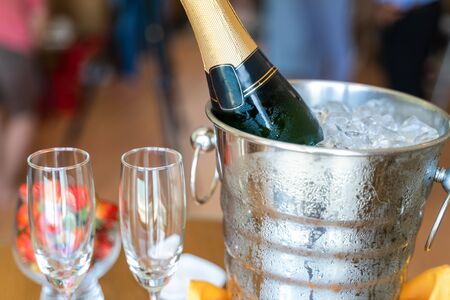 Wineglass and a bottle of chilled champagne are in an ice bucket for welcoming guests in hotelの写真素材