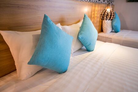 Blue soft pillows on a bed in hotelの写真素材