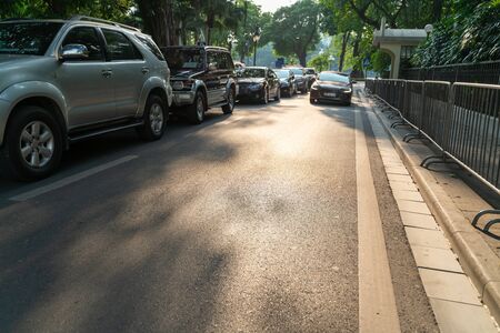 Copy space street with cars parking on urban street under brilliant sunlightの写真素材