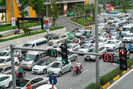 Traffic light with street traffic on background in Hanoi streetの写真素材