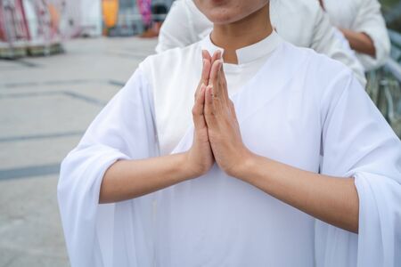 Hands making buddhist pray gesture in Oriental cultureの写真素材