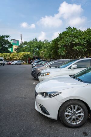 Cars in the parking lot in row with blue skyの写真素材