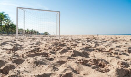 Soccer goal post on the beach with sand and blue skyの写真素材