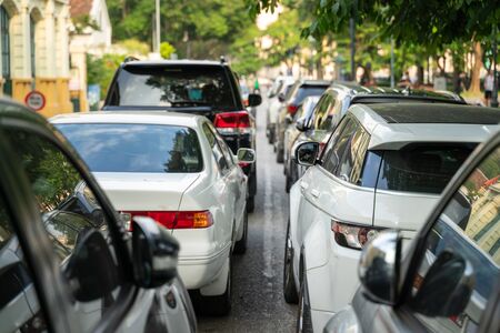 Long line of cars on urban street with rear viewの写真素材
