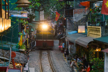 Train passing narrow road in old town in Hanoiのeditorial素材