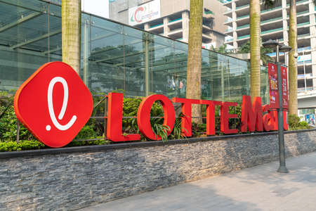 Hanoi, Vietnam - Mar 21, 2019: Lotte Mart logo sign of Lotter Center Hanoi at Dao Tan - Lieu Giai street, with logo sign and advertisement bannersのeditorial素材