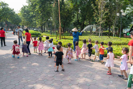 Hanoi, Vietnam - Oct 9, 2018: Kids of a garten class go out on Dinh Tien Hoang streetのeditorial素材