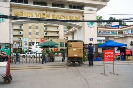 Hanoi, Vietnam - Mar 31, 2020: Control activities at main entrance of Bach Mai hospital, locked down as a major Covid-19 outbreak area, during covid-19 coronavirus pandemicのeditorial素材