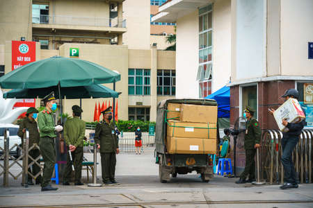 Hanoi, Vietnam - Mar 31, 2020: Control activities at main entrance of Bach Mai hospital, locked down as a major Covid-19 outbreak area, during covid-19 coronavirus pandemicのeditorial素材