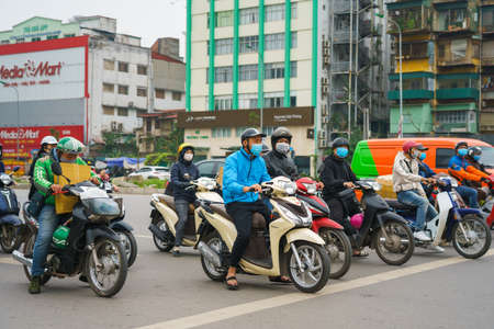 Hanoi, Vietnam - Apr 1, 2020 : People on street wearing face mask to protect against covid-19...