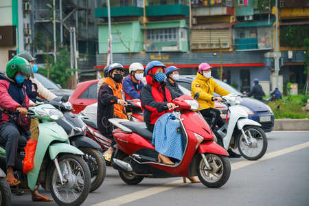 Hanoi, Vietnam - Apr 1, 2020 : People on street wearing face mask to protect against covid-19 coronavirus during outbreak pandemic on Truong Chinh streetのeditorial素材