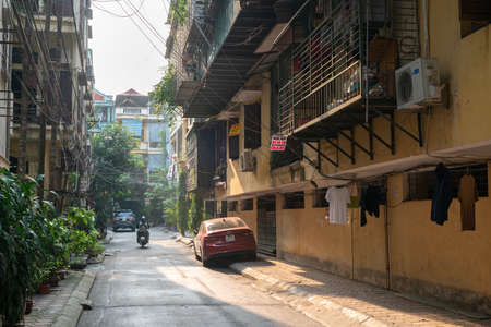 Hanoi, Vietnam - Mar 21, 2019: Narrow old alley with old aparment and a car parking at Dao Tan streetのeditorial素材