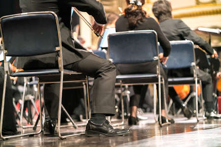 Musician play violin. Violinist playing the violin stringst on the concert stage. Closeup.の写真素材